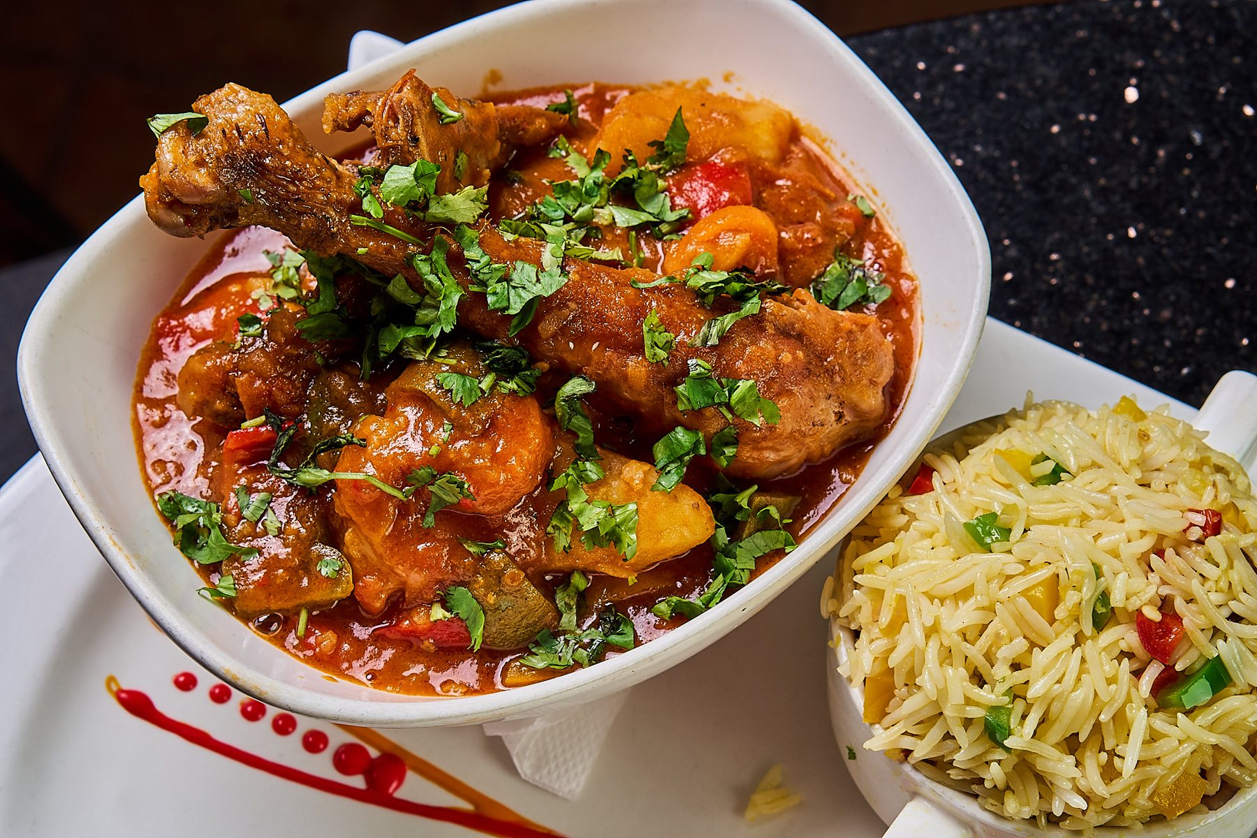 Villa chicken stew served with vegetable rice