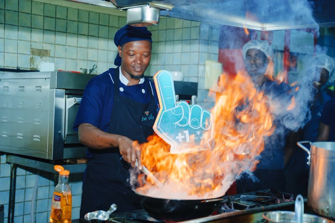 Villa chef flambéing in the kitchen